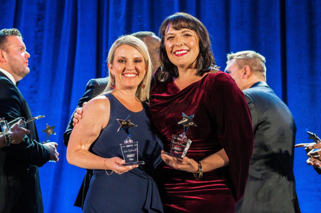 Instant Teams Founders Liza Rodewald and Erica McMannes pose with awards from the Mighty 25 Gala